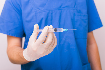 A doctor using syringe. Medical, immunization and vaccination concept.