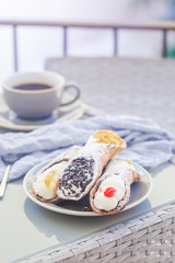 A scrumptious plate of Sicilian Cannoli with chocolate chips. A yummy treat dessert