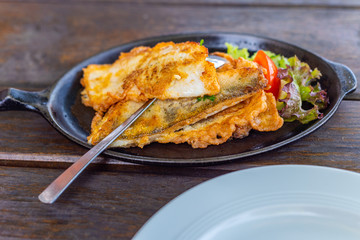 Main dish a fish pan with  potatoes