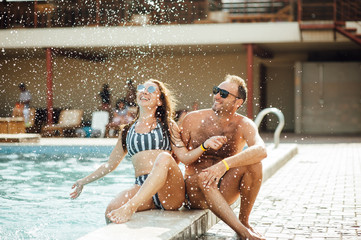 beautiful couple having fun by the pool