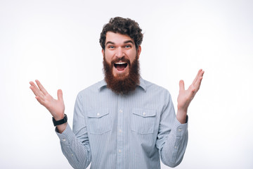 Fototapeta premium Photo of surprised man in casual gesturing with hands and screaming