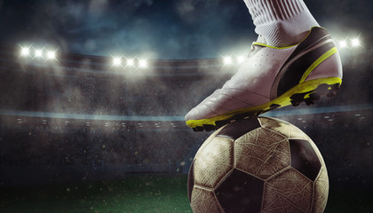 Close up of a soccer striker ready to kicks the ball at the stadium - obrazy, fototapety, plakaty