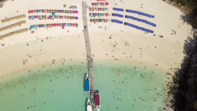 Aerial of cabin cruiser and speedboath on the big ocean in Andaman at Koh Racha Yai, tourism sunbathe, swiming and playing games on the beach, Phuket, Thailand (Video from drone)