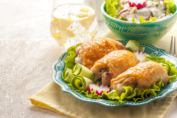 Stuffed chicken roasted thighs with vegetable garnish and herbs.