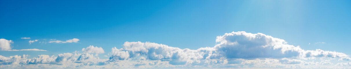 amazing cloud formations on a bright blue sky. beautiful side lit cloudscape panorama in springtime
