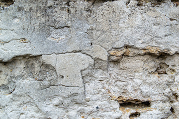 The texture of the old concrete wall. Raw plaster wall background. The wall is made of natural stone shell rock.