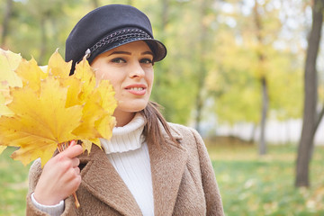 Beautiful gentle woman in the autumn park