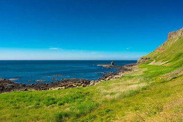 Fototapeta na wymiar Giants Causeway Aerial view most popular and famous attraction in Northern Ireland.Hills on Coast of Atlantic ocean, summer time 