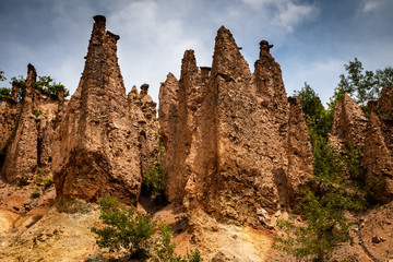 Fototapeta na wymiar Devil's town (Djavolja Varos), Sandstone structures with stones on top. Interesting rock formations made by strong erosion on Radan mountain in Serbia.