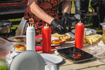 Coocking bbq beef burgers in summer festival
