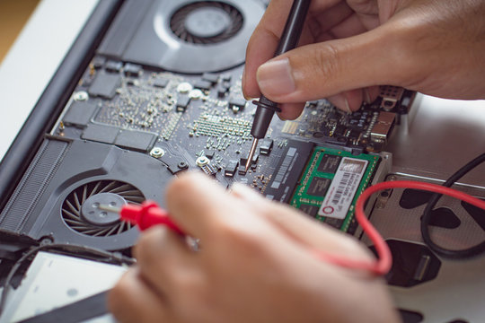 Professional engineer man fixing hardware computer board.
