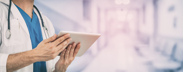 Doctor using tablet computer at the hospital. Medical healthcare and doctor staff service.