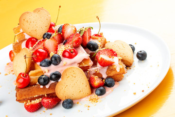 Belgian waffles with topping, cherries, strawberries and berries.