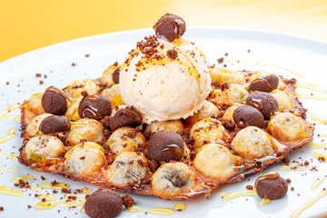 Bubble waffles with ice cream and chocolate chip cookies. On white background