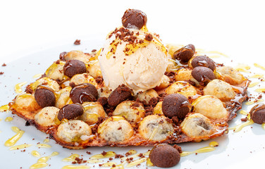Bubble waffles with ice cream and chocolate chip cookies. On white background