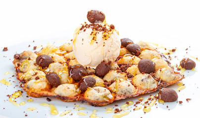 Bubble waffles with ice cream and chocolate chip cookies. On white background