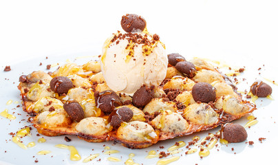 Bubble waffles with ice cream and chocolate chip cookies. On white background