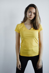 woman in yellow T-shirt and black pants has spots because she has worked with certain chemical substances. close up photo. isolated white background, studio shot.