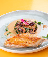 Fried chicken breast, with stewed spinach and grapes.