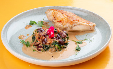 Fried chicken breast, with stewed spinach and grapes.