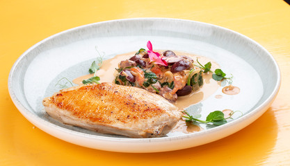 Fried chicken breast, with stewed spinach and grapes.