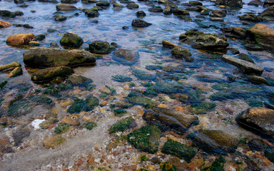 Fototapeta na wymiar Beautiful seaside boulders and bright sea water