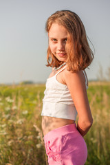 Fototapeta na wymiar Child girl on the background of the summer field.