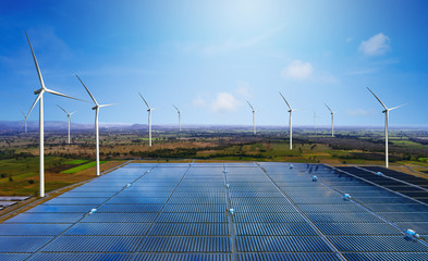 Solar energy panel photovoltaic cell and wind turbine farm power generator in nature landscape for...