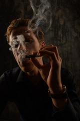Brutal Mystery man with cigar and smoke isolated on black background