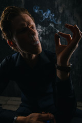 Brutal Mystery man with cigar and smoke isolated on black background