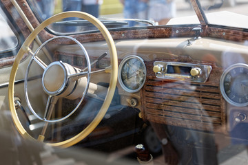Fototapeta na wymiar Old cabin, console and steering wheel in a vintage retro car