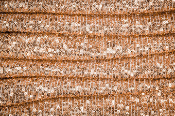 Cloth sequins gold background texture. Textile disco style.