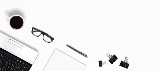 Top view education and office desk with laptop, Coffee, glasses, Pen, Paper clip, Paper with copy space and gray background, Tilt angle