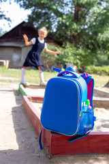 School bag and an elementary student on playground