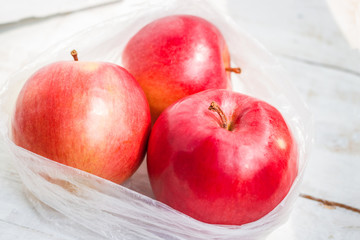 red apples in plastic bag close up