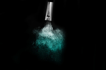 Cosmetic brush with blue cosmetic powder spreading for makeup artist and graphic design in black...