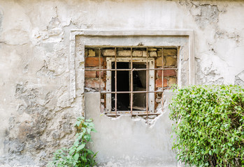 Fototapeta na wymiar Petrovaradin, Serbia - July 17. 2019: Petrovaradin fortress; Ruined windows of the building at the foot of the fortress