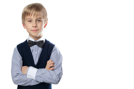 Portrait of blonde boy in classic suit with bow tie.