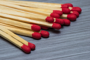 Close up on Loose safety Matches, brushed metal background