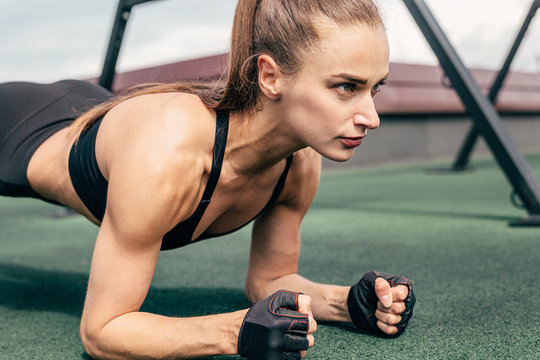 Cropped shot of a young woman  doing planking exercise outdoors