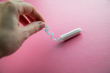Frau mit Tampon auf Rosa Hintergrund für weibliche Hygiene bei Menstruation Periode Zyklus