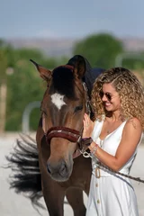 Foto op Canvas blonde girl stroking a horse © alvaroatalaya
