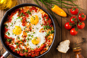 Shakshouka, dish of eggs poached in a sauce of tomatoes, chili peppers, onions