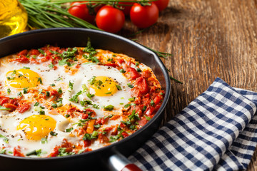 Shakshouka, dish of eggs poached in a sauce of tomatoes, chili peppers, onions