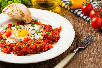 Shakshouka, dish of eggs poached in a sauce of tomatoes, chili peppers, onions