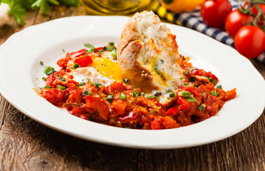 Shakshouka, dish of eggs poached in a sauce of tomatoes, chili peppers, onions