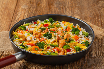 Nasi goreng. Fried rice with egg and vegetables.