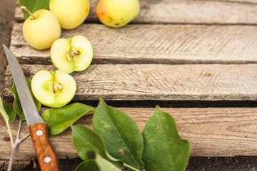 apples, fruits and petals (yellow and green variety of apples, cut into pieces slices). top food background. copy space