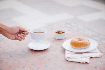 cup of coffee with bread on table in the morning with sunlight, breakfast