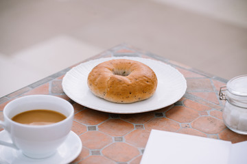 cup of coffee with bread on table in the morning with sunlight, breakfast